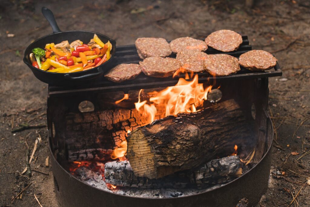 cooking beef burgers on open fire