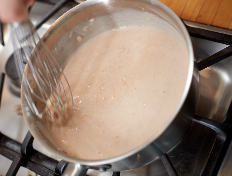preparing smoked gouda philly cheesesteak sauce - butter flour and gouda