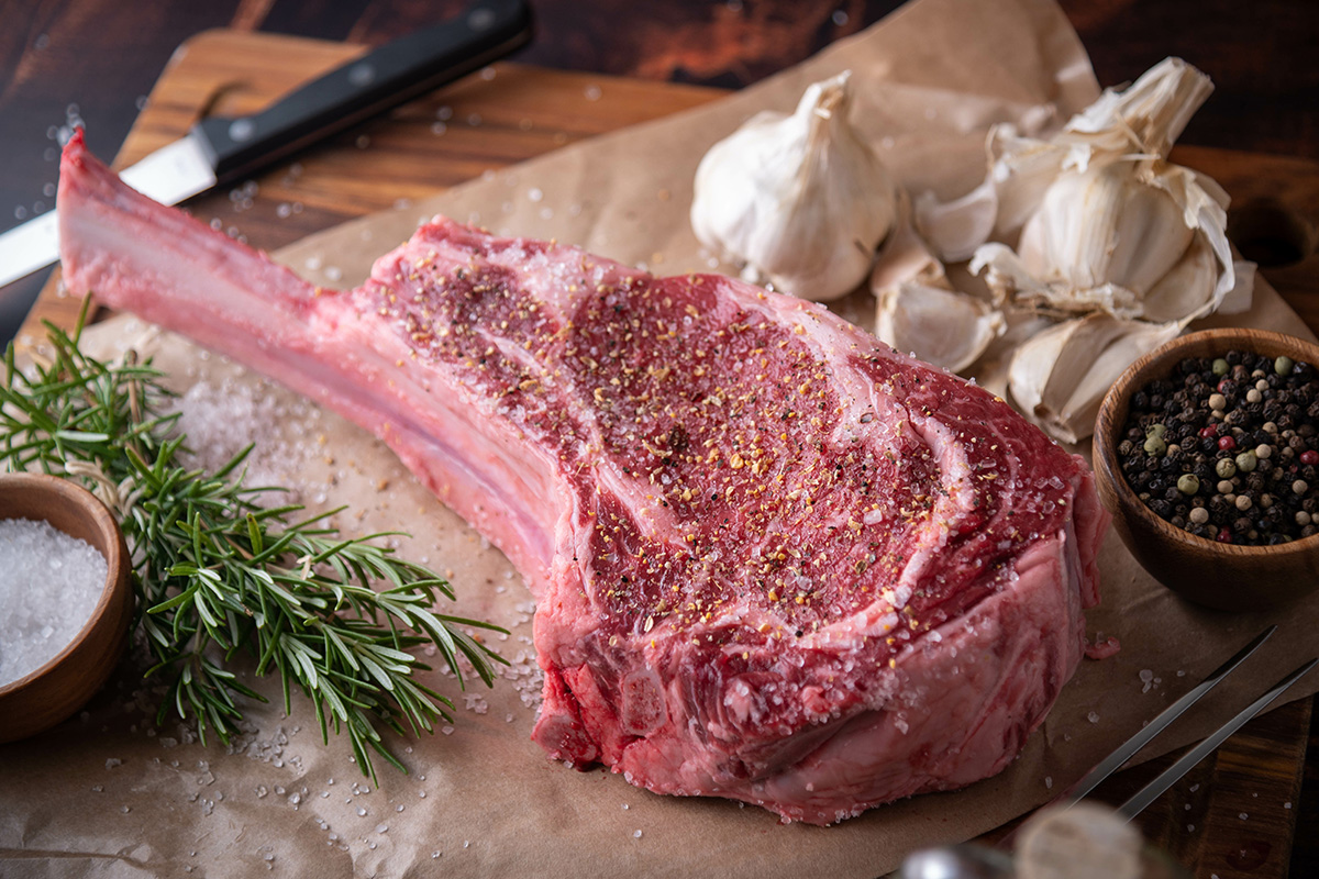 uncooked seasoned tomahawk steak